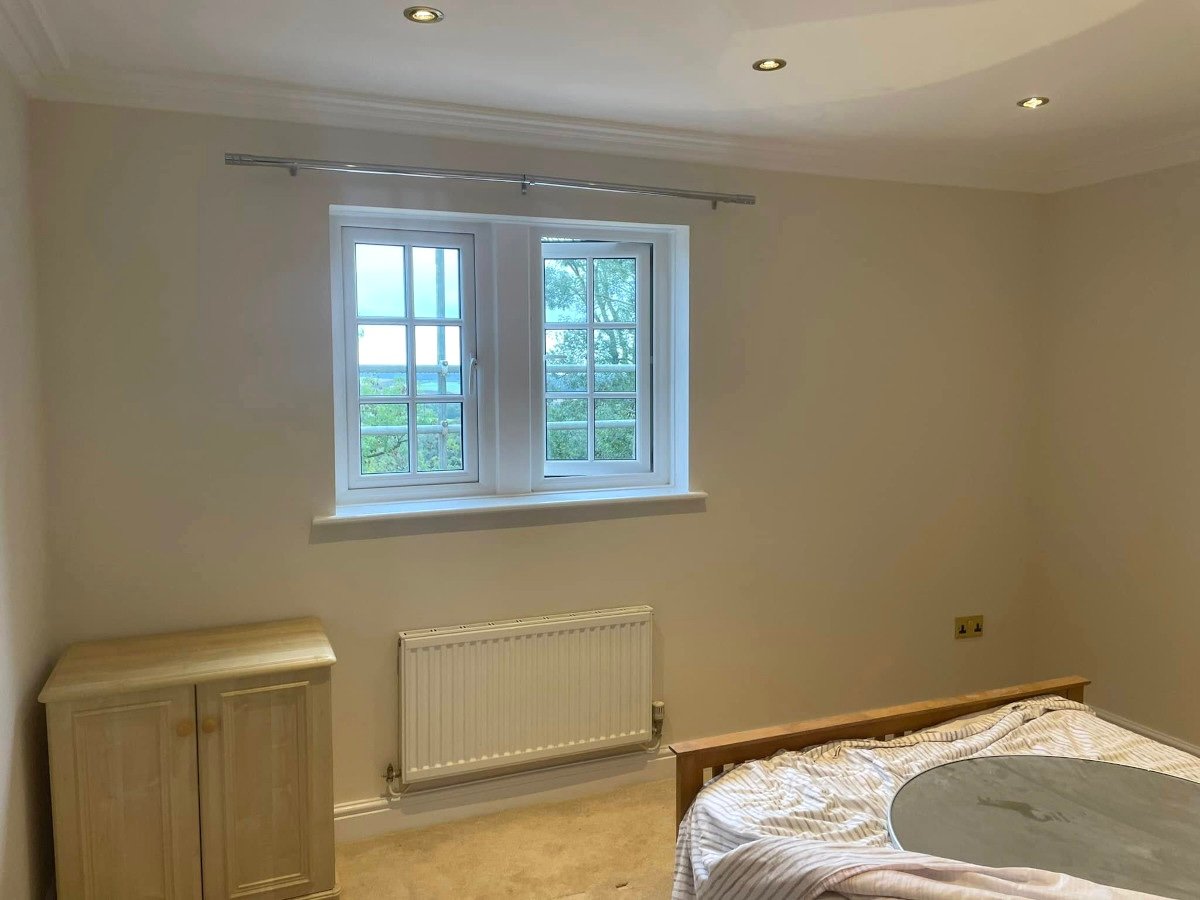 bedroom cream painted walls double windows newport orchid decor