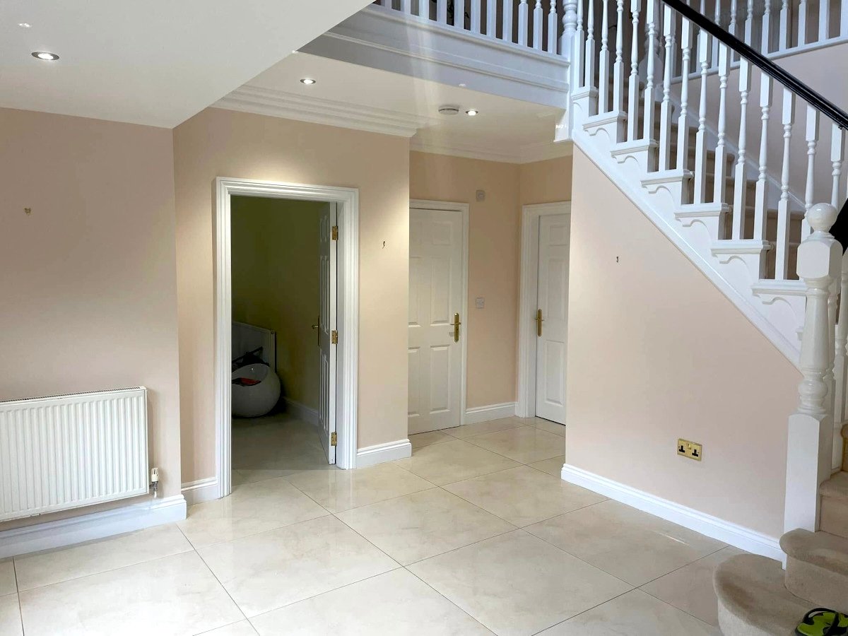 entryway cream painted walls staircase tiled floor newport orchid decor