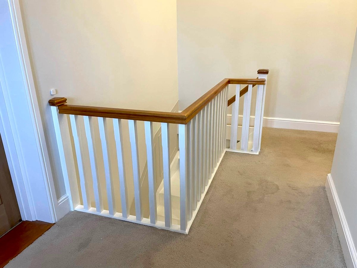 landing cream painted walls white banister staircase newport orchid decor