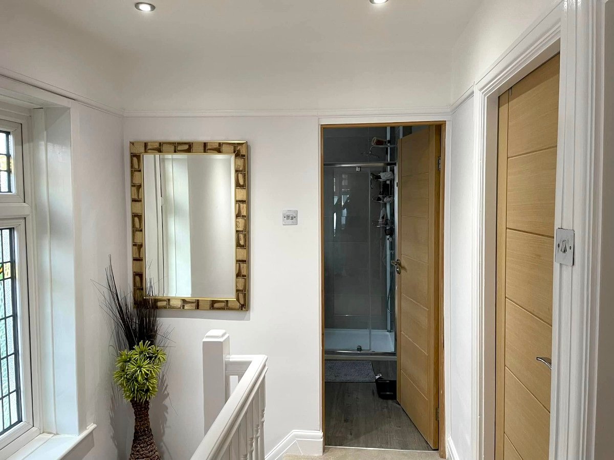 living room beige painted walls leather sofa chandelier newport orchid decor